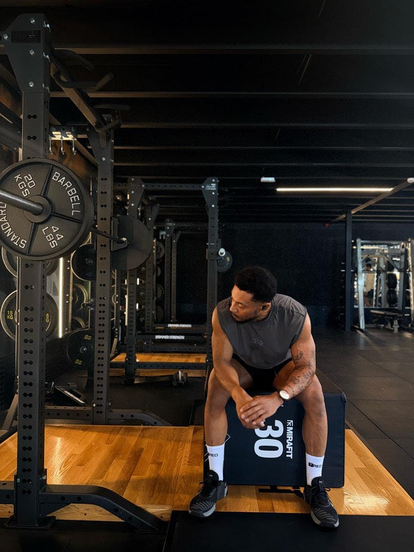 Athlete resting on a plyo box in white TRED socks