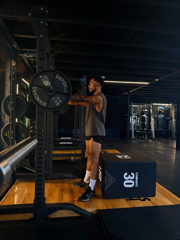 Athlete at a squat rack in white TRED socks