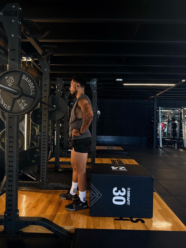 Athlete by the squat rack in white TRED socks