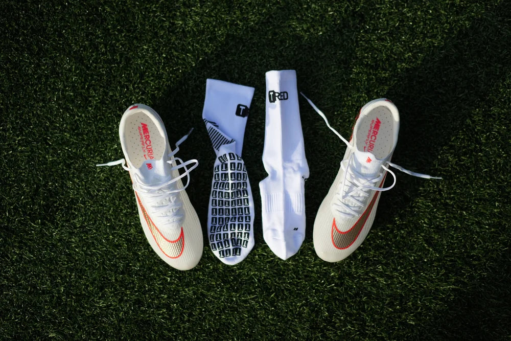 Branded grip socks laid out with boots