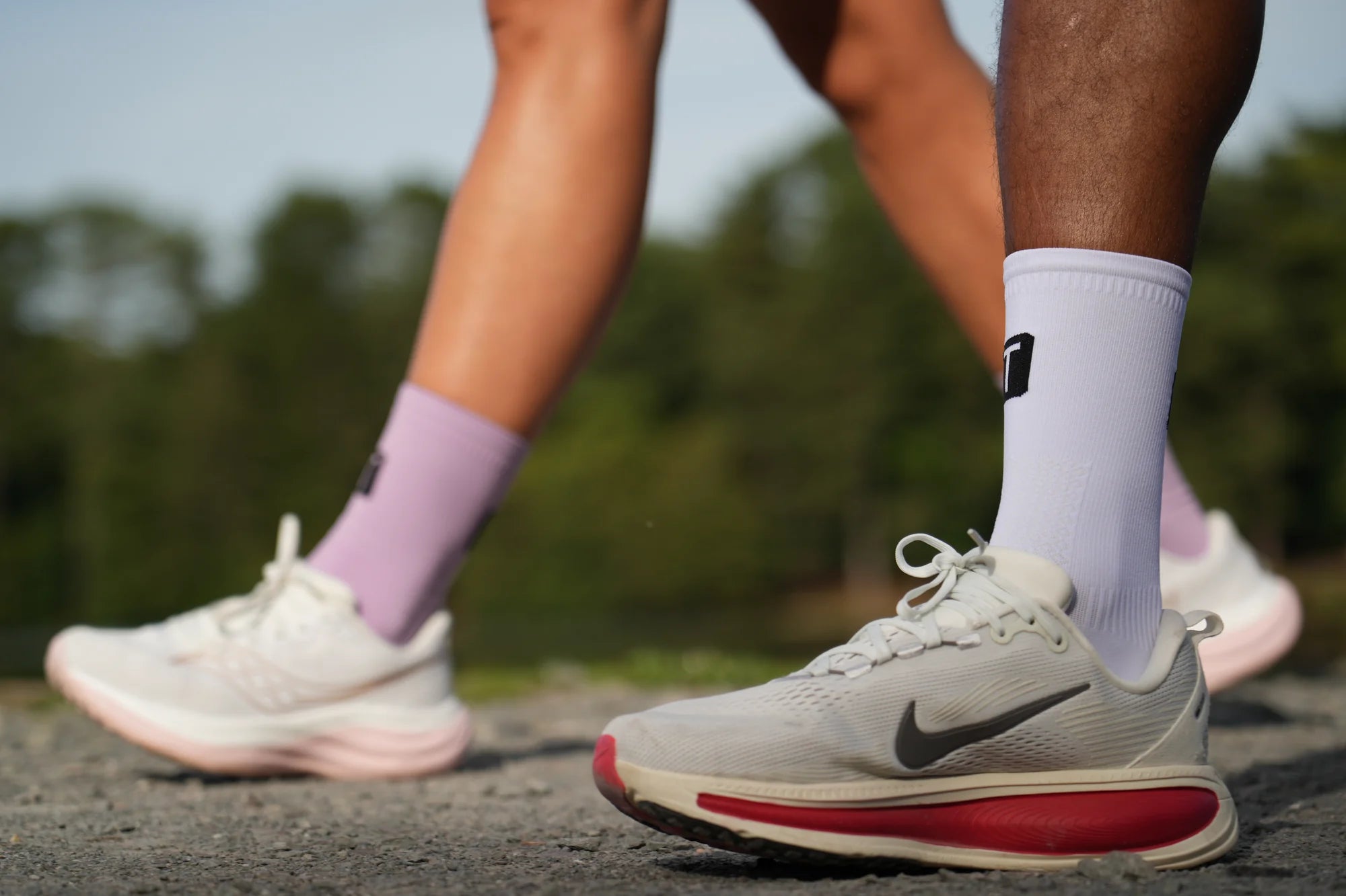 Lilac and white TRED Runners on a park path