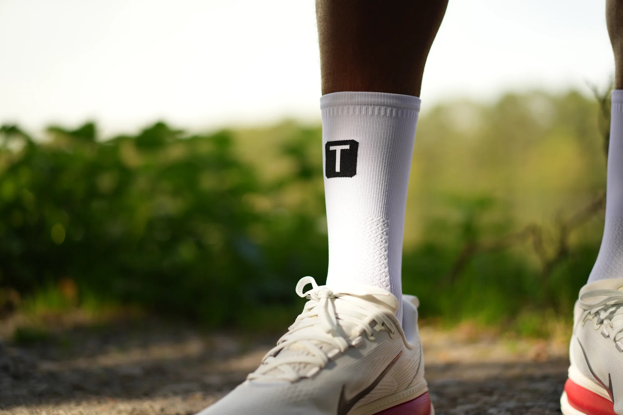 Close-up of a white TRED Runner sock and trainer