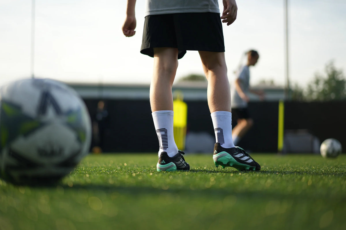 Junior footballer in white TRED 2.0 grip socks