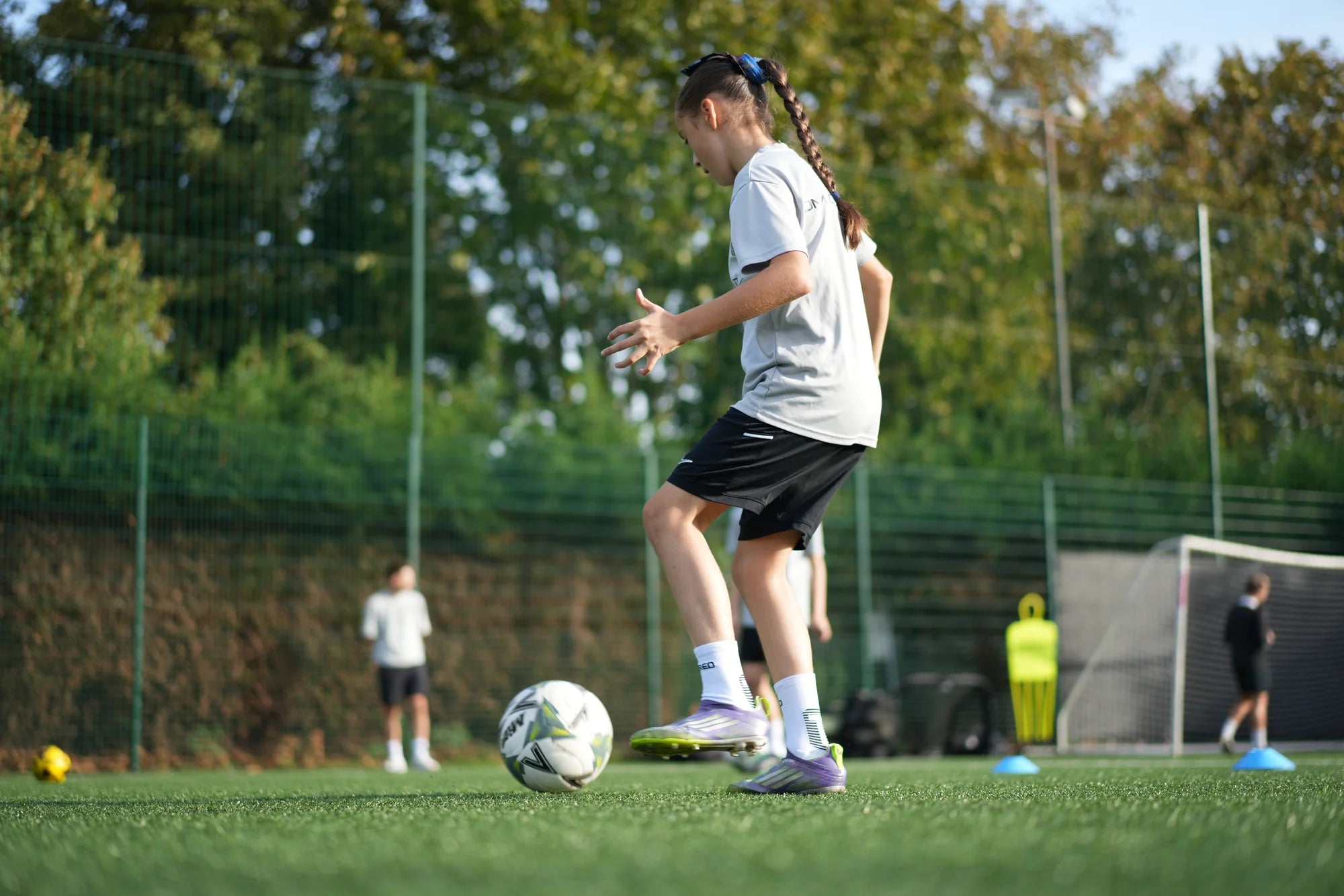 Young player dribbling at training