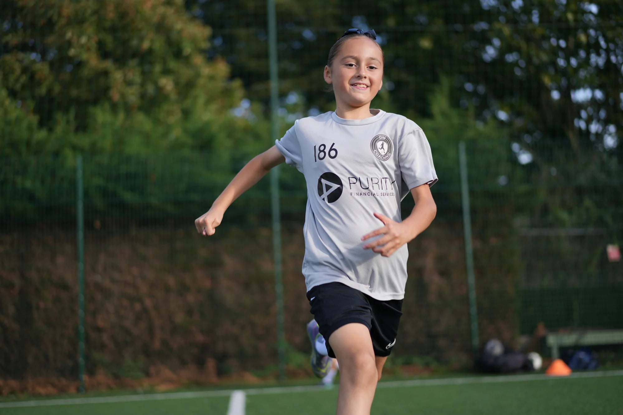 Young player sprinting on an artificial pitch