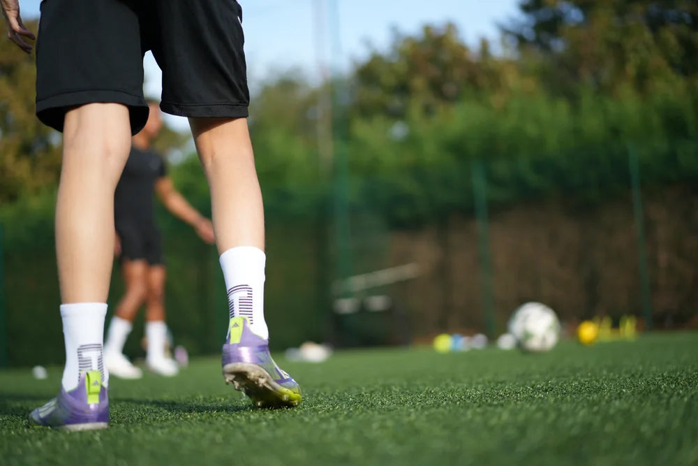 Young player wearing TRED 2.0 grip socks