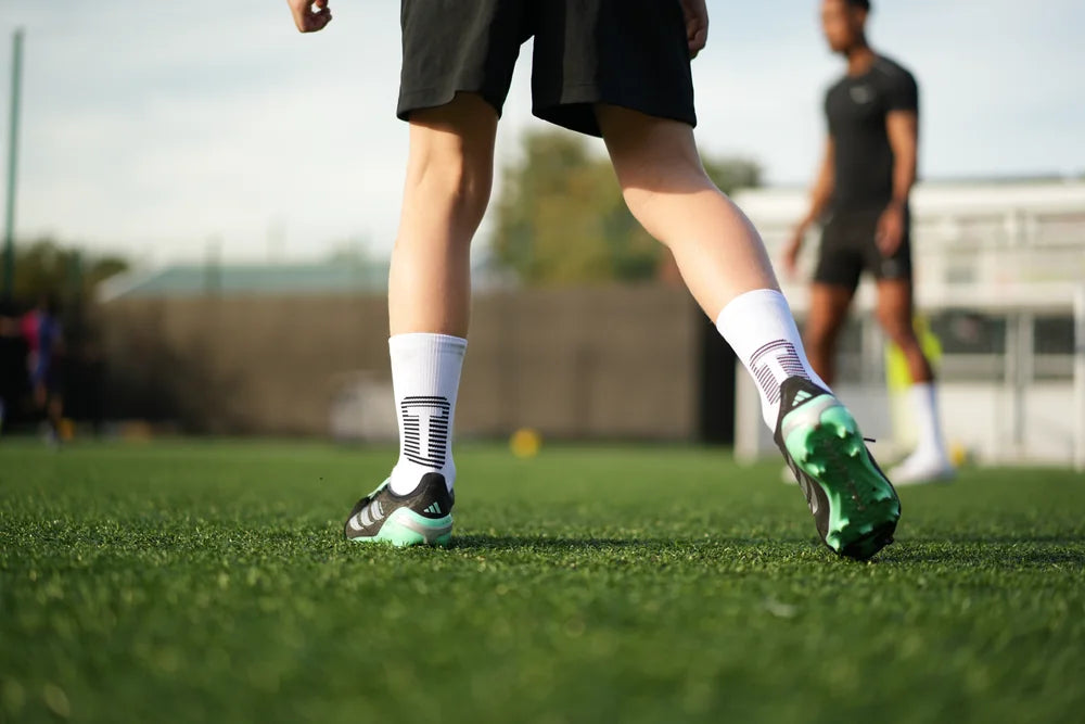 Young player wearing TRED 2.0 grip socks